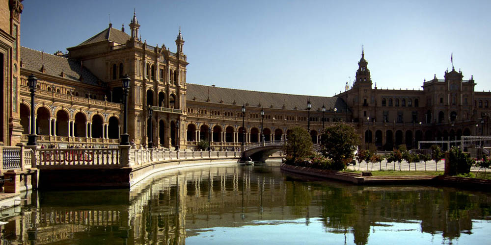 Historic Plaza de España in Seville with ornate architecture and canal, featured on Spanish Al Andalus luxury train route