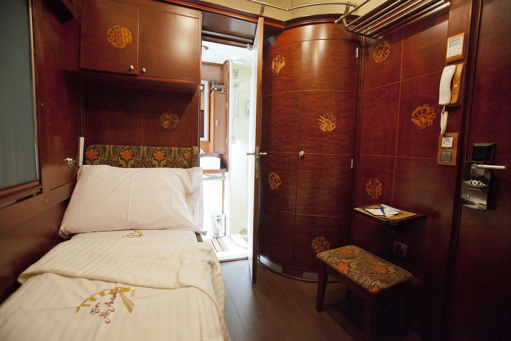 Luxury train cabin interior at night, bed, and private bathroom on Al Andalus